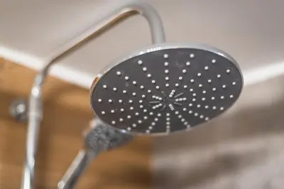 a black shower head in a shower at Exeptional Apartment in Athens