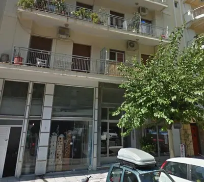 a building with a motorcycle parked in front of it at Exeptional Apartment in Athens