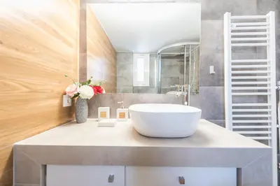 a bathroom with a large white tub on a counter at Exeptional Apartment in Athens