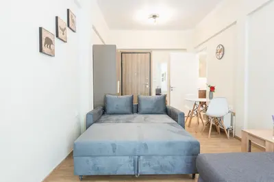 a bedroom with a blue bed and a table at Exeptional Apartment in Athens
