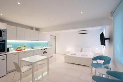 a kitchen with a couch and a table and chairs at Cute and Convenient Studio in Athens Center in Athens