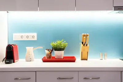 a kitchen counter with a plant in a vase on it at Cute and Convenient Studio in Athens Center in Athens