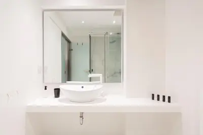 a white bathroom with a sink and a mirror at Cute and Convenient Studio in Athens Center in Athens