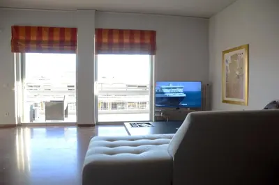 a living room with a couch and a tv at Modern & Classy Central Apartment in Athens