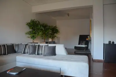a living room with a white couch with pillows at Modern & Classy Central Apartment in Athens
