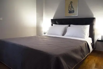 a bedroom with a large bed with white pillows at Modern & Classy Central Apartment in Athens