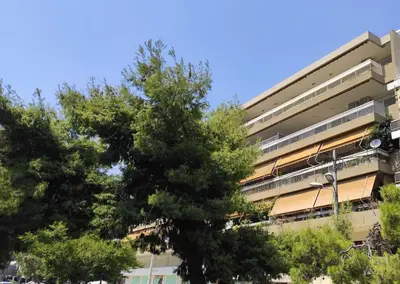 an apartment building with trees in front of it at Modern & Classy Central Apartment in Athens