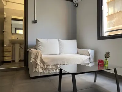 a living room with a couch and a table at Virginia's Boutique Apartments in Athens