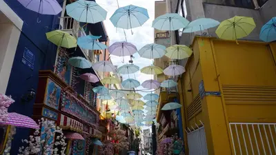 a bunch of umbrellas hanging above a street at Virginia's Boutique Apartments in Athens