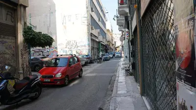 a red car parked on the side of a street at Virginia's Boutique Apartments in Athens