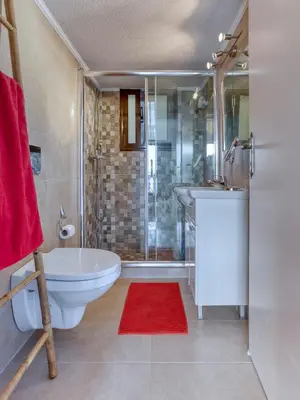 a bathroom with a tub and a sink and a shower at Varkiza by the sea in Vari