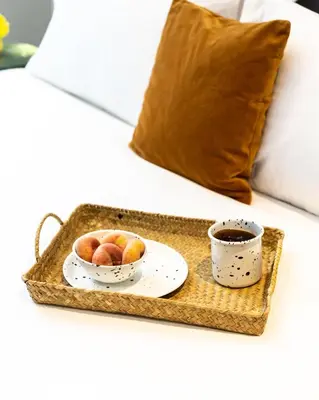 a tray with a bowl of fruit and a cup of coffee at PAME Paradiso in Athens