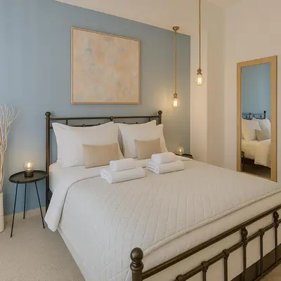 a bedroom with a large bed with two white pillows at Stylish, Comfy Suite in the Heart of Athens in Athens