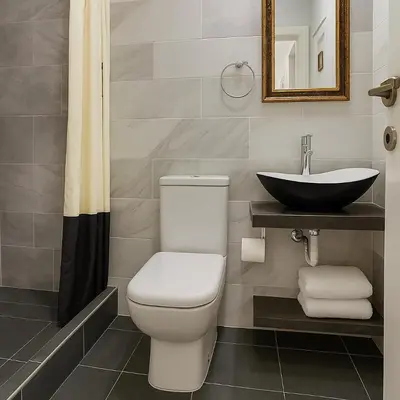 a bathroom with a toilet and a sink at Stylish, Comfy Suite in the Heart of Athens in Athens