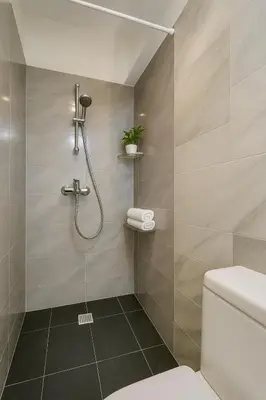 a bathroom with a shower and a toilet at Stylish, Comfy Suite in the Heart of Athens in Athens