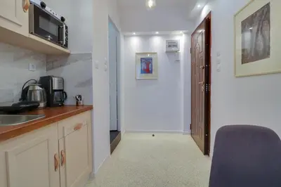 a kitchen with a sink and a door to a hallway at Stylish, Comfy Suite in the Heart of Athens in Athens