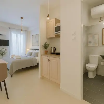 a bedroom with a bed and a bathroom with a toilet at Stylish, Comfy Suite in the Heart of Athens in Athens