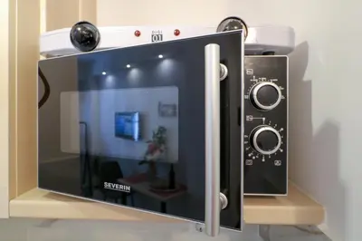 a microwave oven with a plant inside of it at Stylish, Comfy Suite in the Heart of Athens in Athens