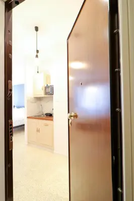 a door leading into a room with a kitchen at Stylish, Comfy Suite in the Heart of Athens in Athens