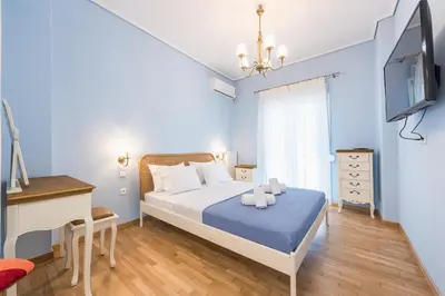 a bedroom with a bed and a desk and a tv at Thissio Cocoon in Athens