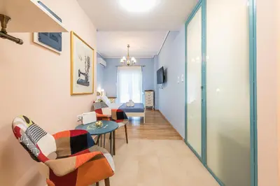 a corridor of a room with chairs and a table at Thissio Cocoon in Athens