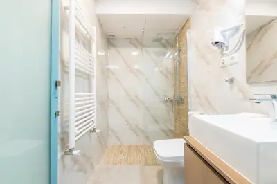 a bathroom with a sink and a toilet at Thissio Cocoon in Athens