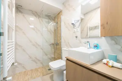 a bathroom with a toilet and a sink and a shower at Thissio Cocoon in Athens