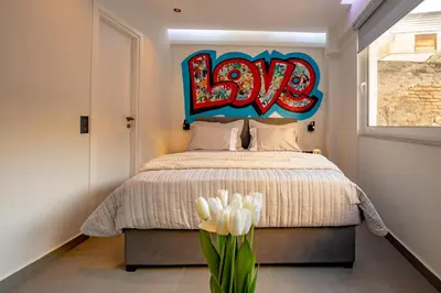 a bedroom with a bed with a sign that says hog at Triple A - Graffiti Homage in Psirri Square - FREE Parking! in Athens