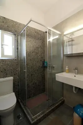 a bathroom with a shower and a toilet and a sink at Luxury flat in Hilton, central Athens, 3' metro, VFM! in Athens