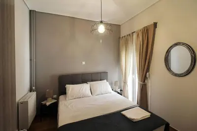 a bedroom with a large bed and a mirror at Luxury flat in Hilton, central Athens, 3' metro, VFM! in Athens
