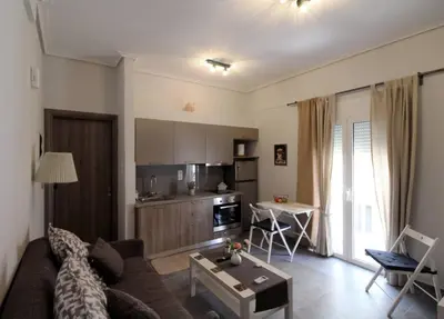 a living room with a couch and a table at Luxury flat in Hilton, central Athens, 3' metro, VFM! in Athens