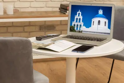 a laptop computer sitting on a white table at SUITES@SYNGROU-FIX in Athens