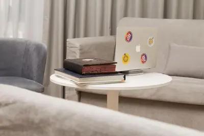 a table with a laptop computer on top of books at SUITES@SYNGROU-FIX in Athens