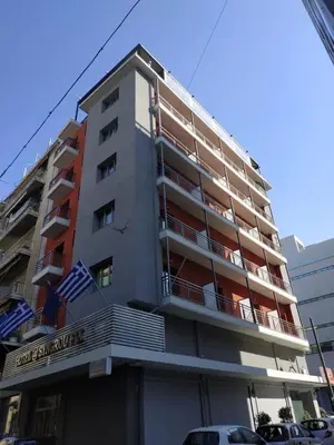a tall apartment building with a sign on it at SUITES@SYNGROU-FIX in Athens