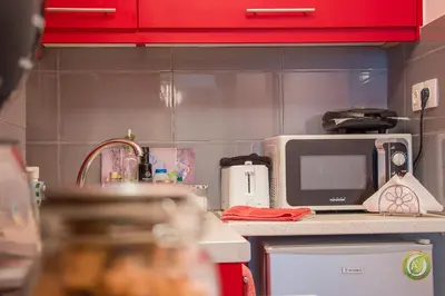 a kitchen with a microwave and a counter with a sink at City Stay close to the National Museum in Athens