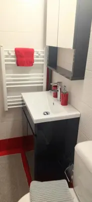 a bathroom with a white sink and a red towel at City Stay close to the National Museum in Athens