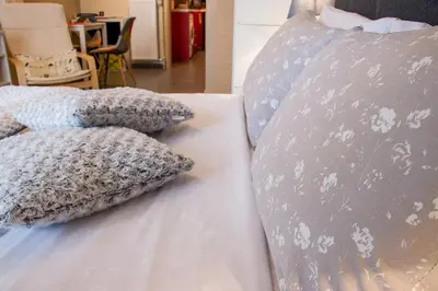 a bed with two pillows on top of it at City Stay close to the National Museum in Athens