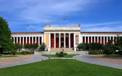 a large building with a flag on top of it at City Stay close to the National Museum in Athens