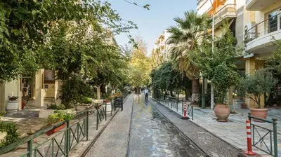 a street in a city with trees and buildings at City Stay close to the National Museum in Athens