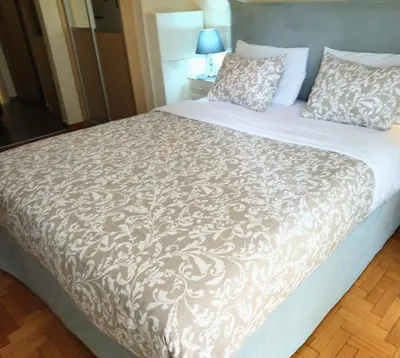 a bedroom with a large bed with a brown and white blanket at City Stay close to the National Museum in Athens