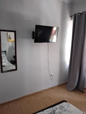 a room with a flat screen tv on a wall at Perikleous Apartment in Athens