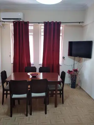 a dining room with a table and red curtains at Perikleous Apartment in Athens