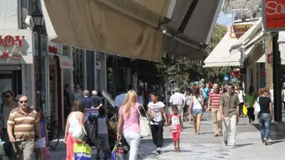 a crowd of people walking down a busy city street at Perikleous Apartment in Athens