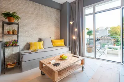 a living room with a couch and a table at Boutique Studios & Apartments - by Avelink in Spáta