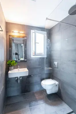 a bathroom with a toilet and a sink at Boutique Studios & Apartments - by Avelink in Spáta