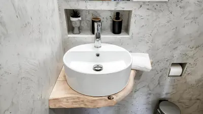 a bathroom with a white sink on a wooden shelf at Boutique Studios & Apartments - by Avelink in Spáta