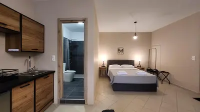 a bedroom with a bed and a bathroom at Boutique Studios & Apartments - by Avelink in Spáta