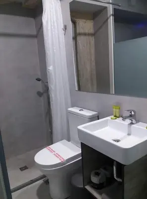 a bathroom with a toilet and a sink and a shower at athens.apartotel.box in Athens