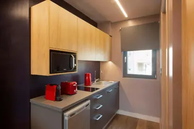 a small kitchen with a sink and a microwave at City Lights Athens by YHA in Athens