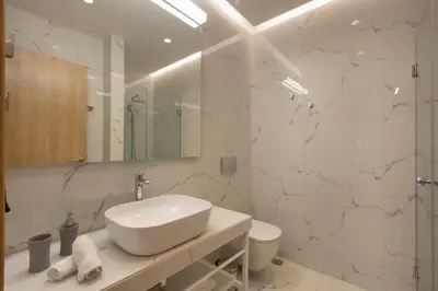 a white bathroom with a sink and a toilet at City Lights Athens by YHA in Athens